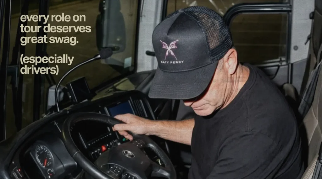 Tour bus driver wearing custom tour merchandise, highlighting the importance of ordering merch for every crew member.