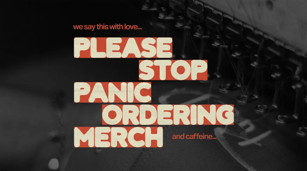 Bold typography blog header reading "Please Stop Panic Ordering Merch" with a distressed cream and red text treatment over a dark moody background of embroidery machinery.