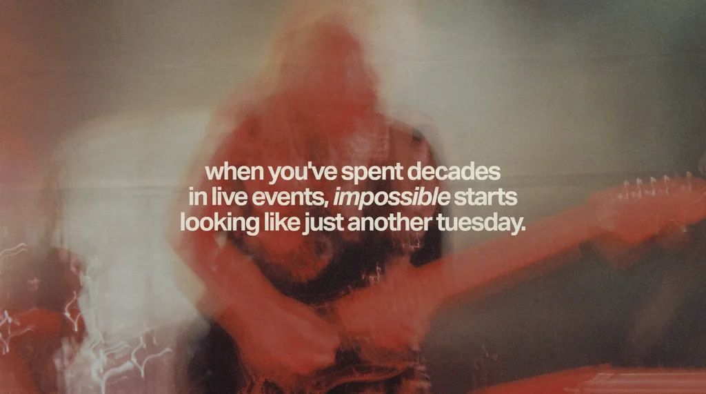 Motion-blurred guitarist performing on stage with text about decades in live events, highlighting branded merchandise expertise and impossible deadlines becoming routine.